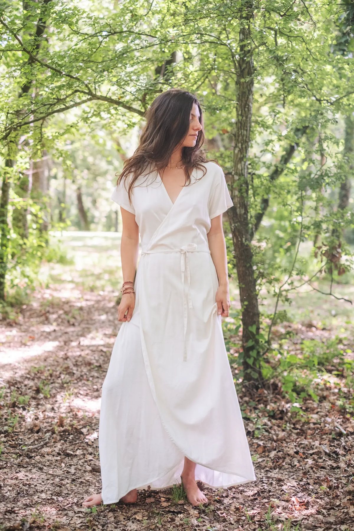 Ana in the forest wearing the tulip wrap dress in white